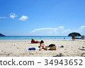 Woman Sunbathing on the Beach 34943652