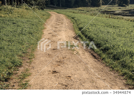 Traces of horseshoes on the sandy dirt road in the 34944874