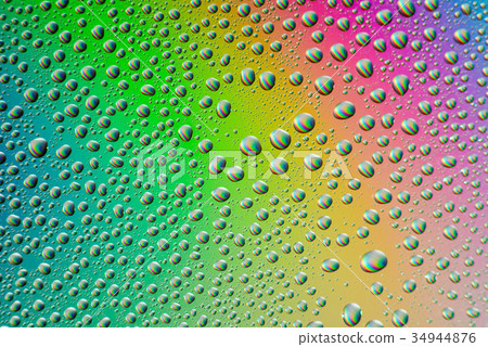 misted glass, drops closeup on rainbow colored 34944876