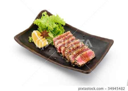 Tataki (tuna fillet) on a black plate isolated Tataki (tuna fillet) on a black plate isolated 34945482
