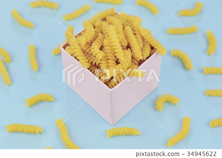 Uncooked italian pasta on blue background. Uncooked italian pasta on blue background. 34945622