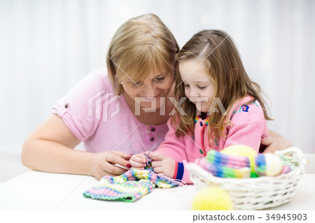 Mother and child knitting. Knit wear. Mother and child knitting. Knit wear. 34945903