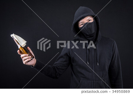 Protester or terrorist holding Molotov cocktail 34950869