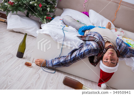 Man suffering hangover after christmas party Man suffering hangover after christmas party 34950941