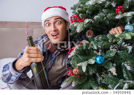 Man suffering hangover after christmas party 34950948