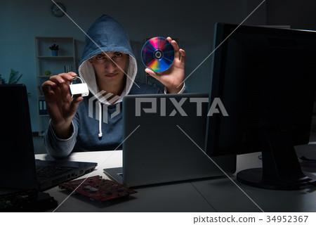 Hacker hacking computer at night Hacker hacking computer at night 34952367
