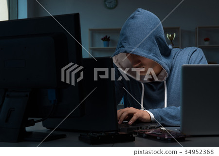 Hacker hacking computer at night Hacker hacking computer at night 34952368