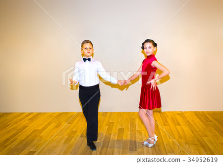 The young boy and girl posing at dance studio The young boy and girl posing at dance studio 34952619