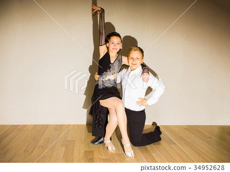 The young boy and girl posing at dance studio 34952628