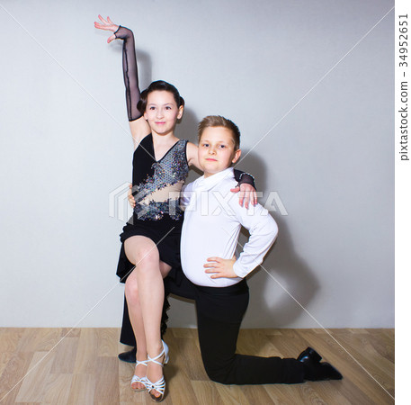 The young boy and girl posing at dance studio The young boy and girl posing at dance studio 34952651