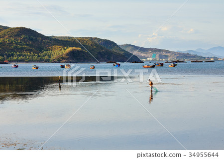 Fishermen are fishing at a lagoon in Phuoc Dong 34955644