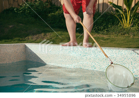 man using net tool scoop up leaf or dirty thing man using net tool scoop up leaf or dirty thing 34955896