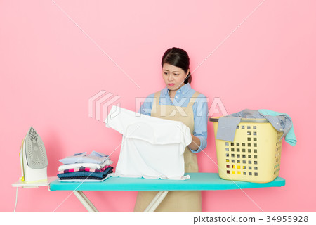 attractive young housewife ironing family clothing attractive young housewife ironing family clothing 34955928