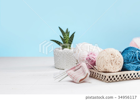 The balls of wool on white wooden background The balls of wool on white wooden background 34956117