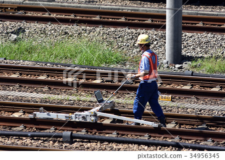 Line maintenance personnel who inspect the track of Tokaido Shinkansen with a small track inspection device Line maintenance personnel who inspect the track of Tokaido Shinkansen with a small track inspection device 34956345
