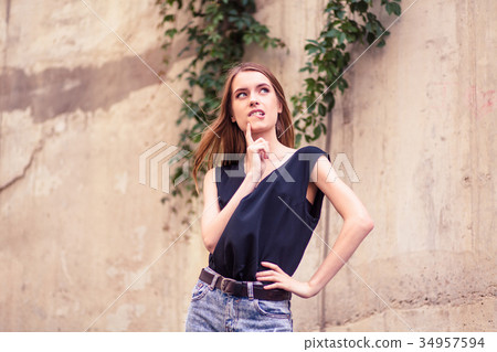 Attractive young woman with thoughtful face. Attractive young woman with thoughtful face. 34957594