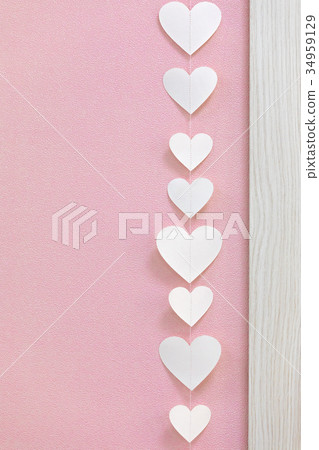 White heart shape garland on pink wall 34959129