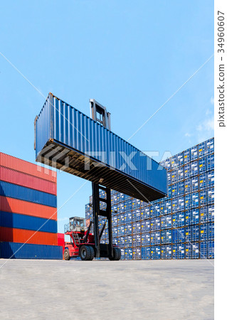 Forklift truck lifting cargo container 34960607