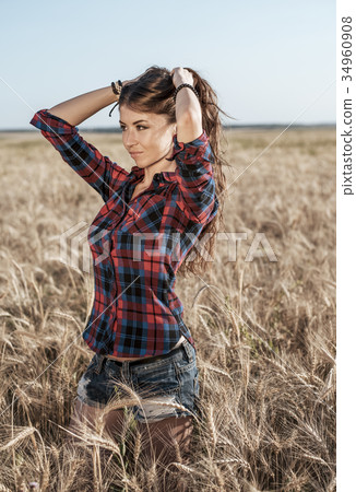 Beautiful happy girl in the field, sunny afternoon Beautiful happy girl in the field, sunny afternoon 34960908