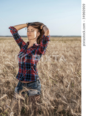 Beautiful happy girl in the field, sunny afternoon Beautiful happy girl in the field, sunny afternoon 34960909