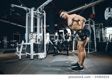 Handsome model young man training back in gym Handsome model young man training back in gym 34960926