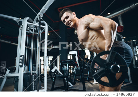 Handsome model young man training back in gym Handsome model young man training back in gym 34960927