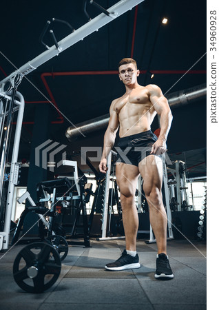 Handsome model young man training legs in gym Handsome model young man training legs in gym 34960928