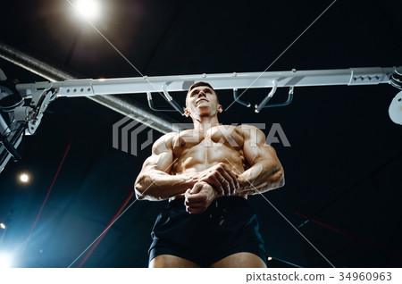 Handsome model young man working out in gym 34960963