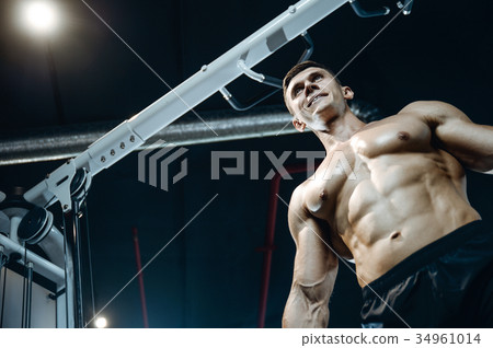Handsome model young man working out in gym Handsome model young man working out in gym 34961014