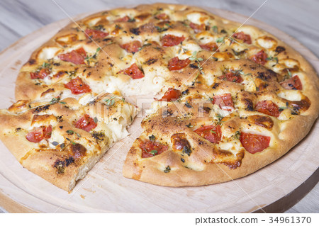 Fresh bread focaccio with cheese and tomatoes Fresh bread focaccio with cheese and tomatoes 34961370