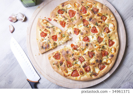 Fresh bread focaccio with cheese and tomatoes Fresh bread focaccio with cheese and tomatoes 34961371