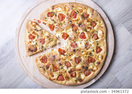 Fresh bread focaccio with cheese and tomatoes Fresh bread focaccio with cheese and tomatoes 34961372