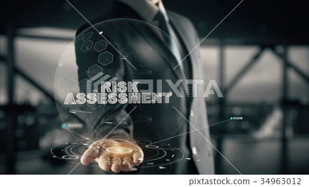 Risk Assessment with hologram businessman concept Risk Assessment with hologram businessman concept 34963012
