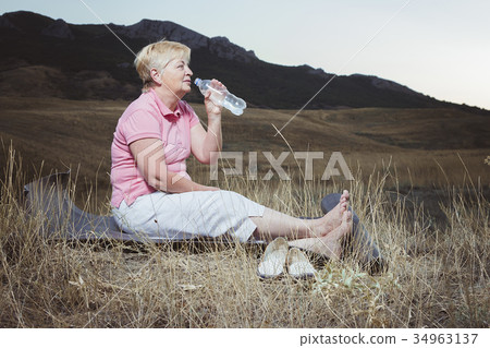 an elderly woman resting after an evening an elderly woman resting after an evening 34963137