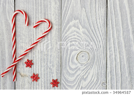Christmas cane decoration on wooden background Christmas cane decoration on wooden background 34964587