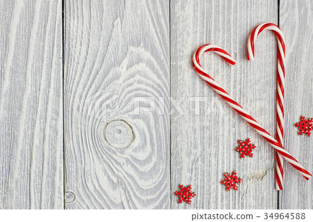 Christmas cane decoration on wooden background Christmas cane decoration on wooden background 34964588