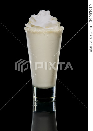 Coconut cream and rum cocktail in highball glass Coconut cream and rum cocktail in highball glass 34965010