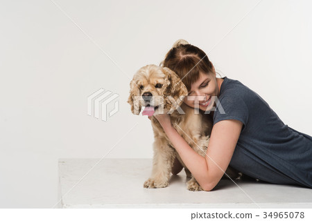 Young woman hugging her spaniel Young woman hugging her spaniel 34965078