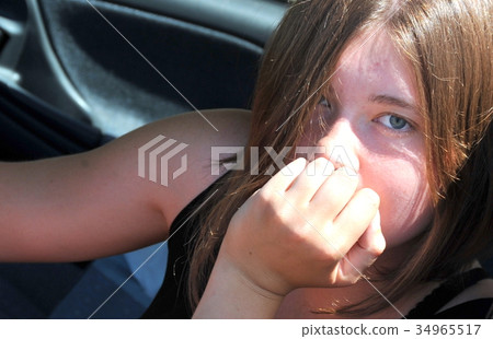 Female driving new car. 34965517