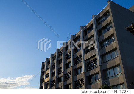 Seismically renovated building that takes in the autumn sunset 34967281