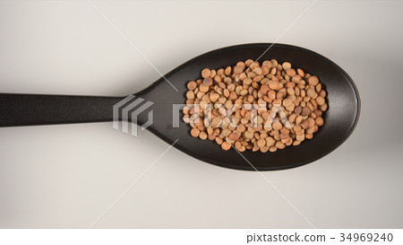 TOP VIEW of lentil in a plastic scoop 34969240