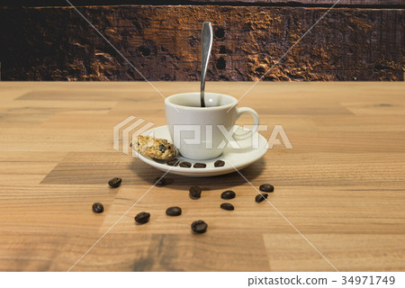 Cup of coffee and a biscuit Cup of coffee and a biscuit 34971749
