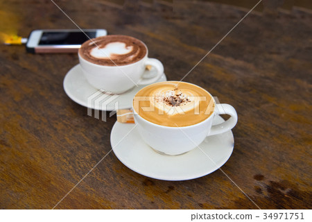 Hot cappuccino coffee and hot chocolate heart shap Hot cappuccino coffee and hot chocolate heart shap 34971751
