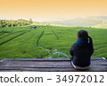 Woman tourism sitting on wood balcony to see view 34972012