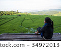 Woman tourism sitting on wood balcony to see view 34972013