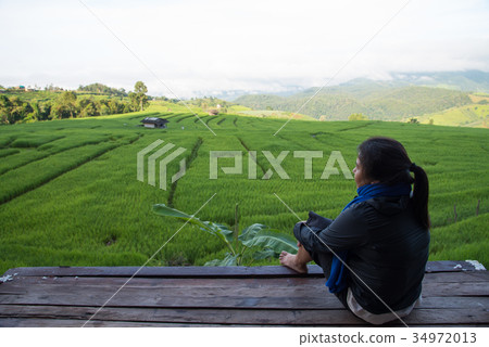 Woman tourism sitting on wood balcony to see view 34972013