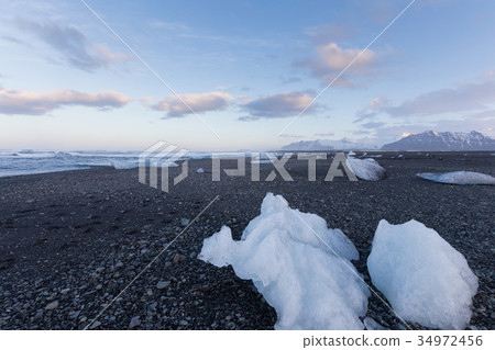 Ice on the beach over seacoast skyline, Iceland  34972456