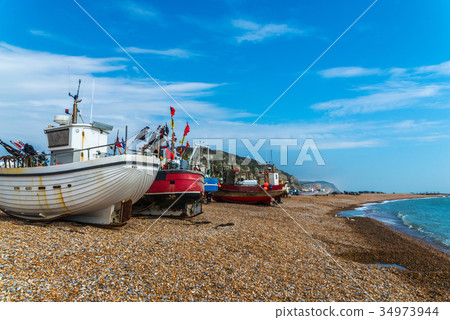 Fishing boats on the shore, pebble beach 34973944