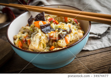 Risotto with chicken and vegetables. Risotto with chicken and vegetables. 34974477