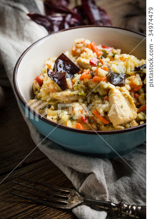 Risotto with chicken and vegetables. Risotto with chicken and vegetables. 34974479